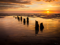 Groynes with Yellow Sunset and Ripples